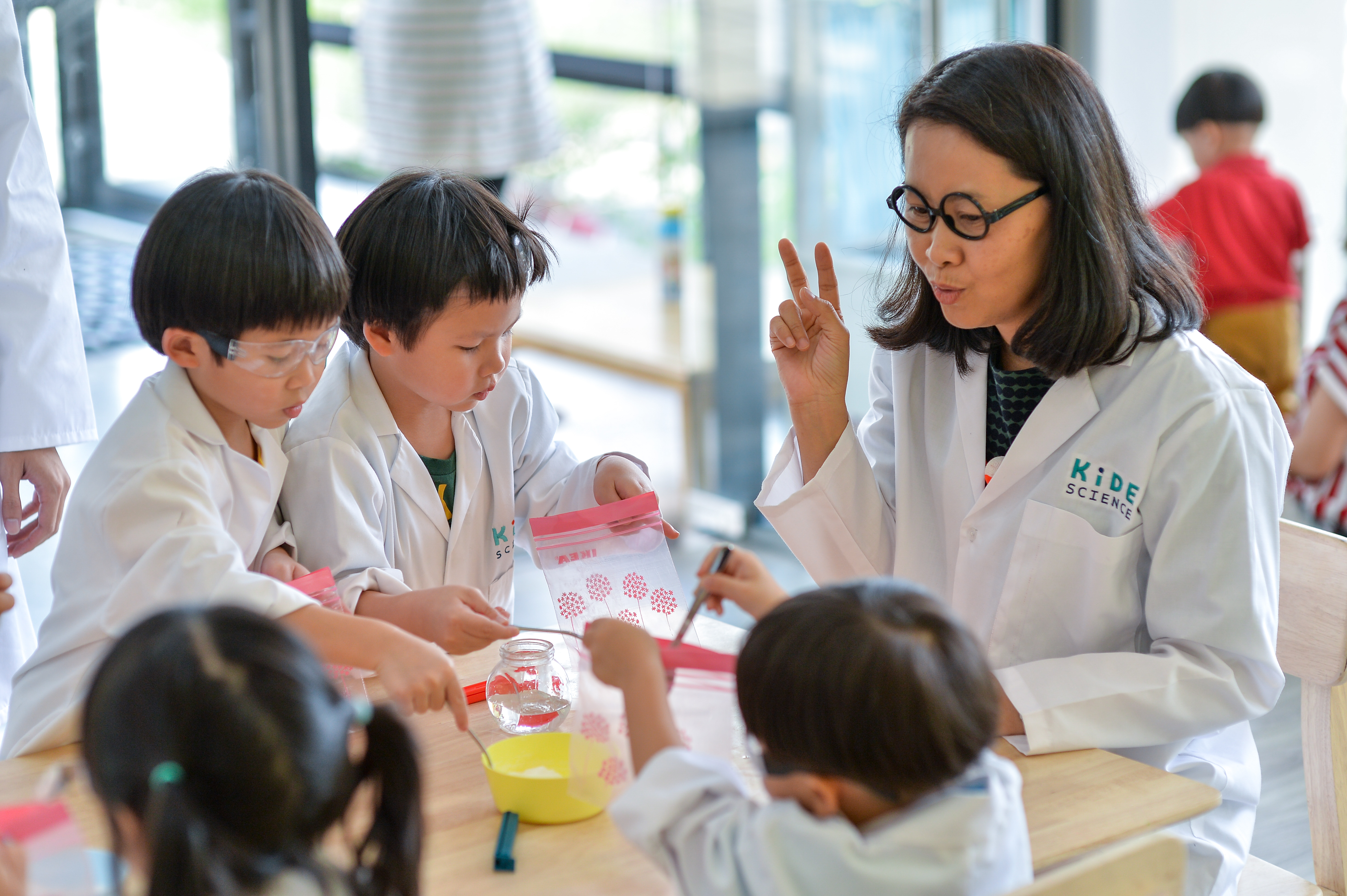 A group of children placing a powder into a baggie